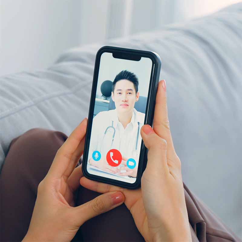 Private GP in mobile video call with patient